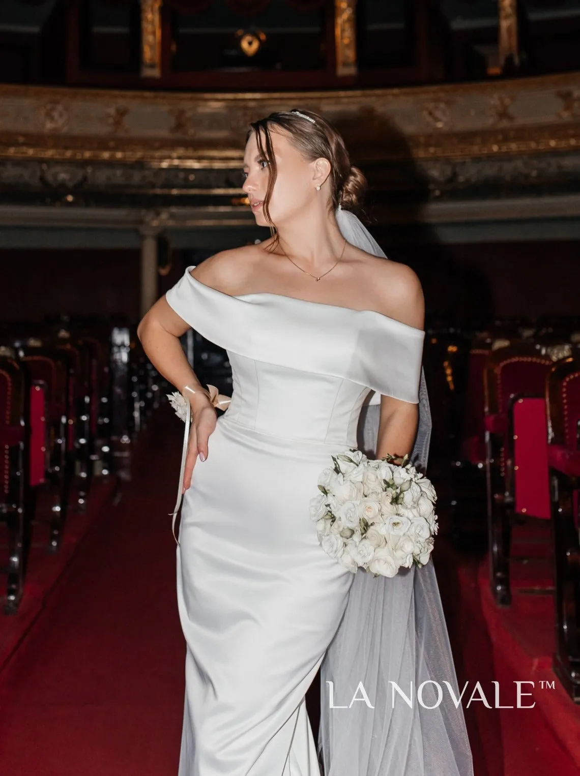 Modern fitted satin bridal gown with Bardot neckline