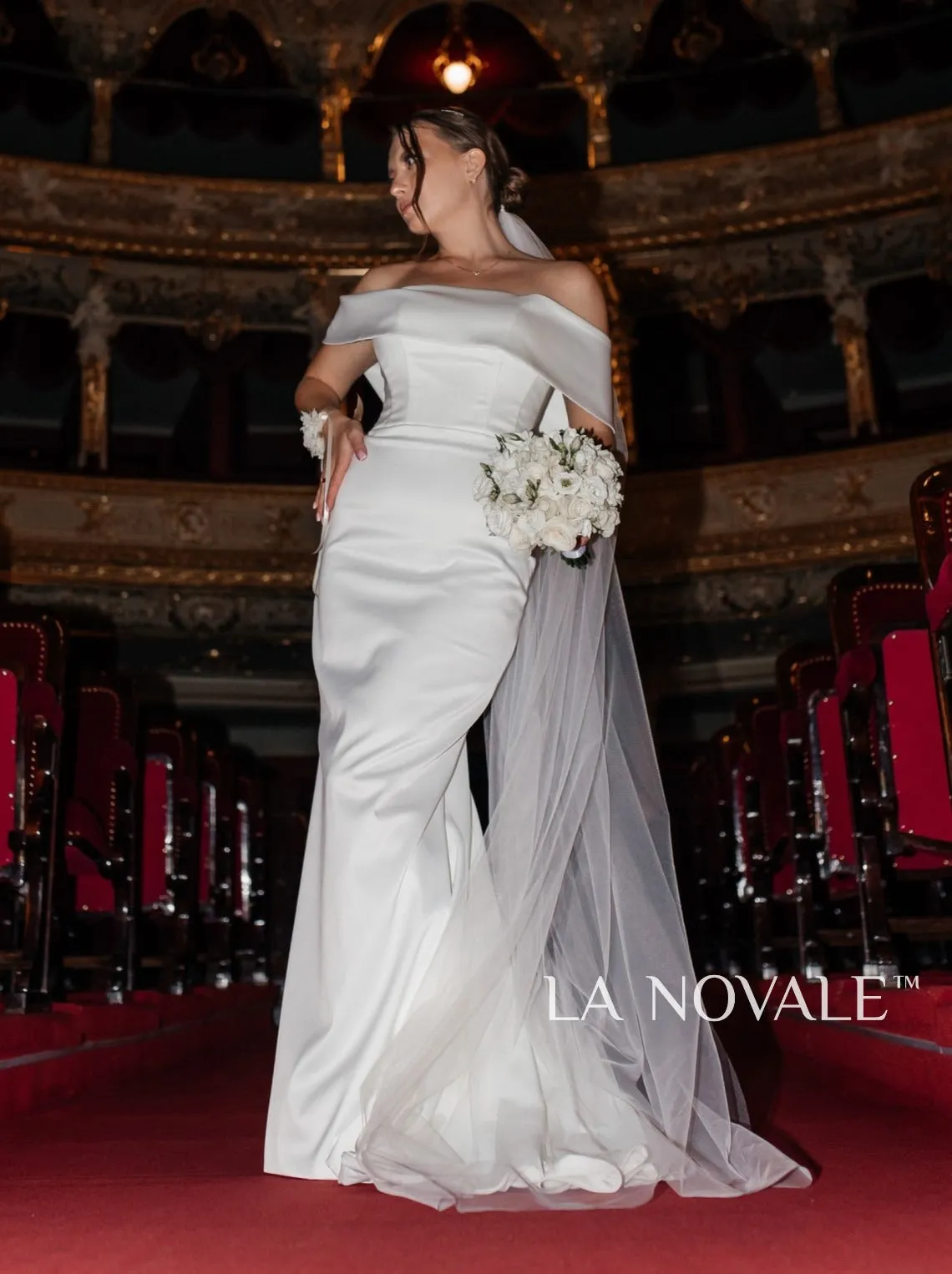 Modern fitted satin bridal gown with Bardot neckline